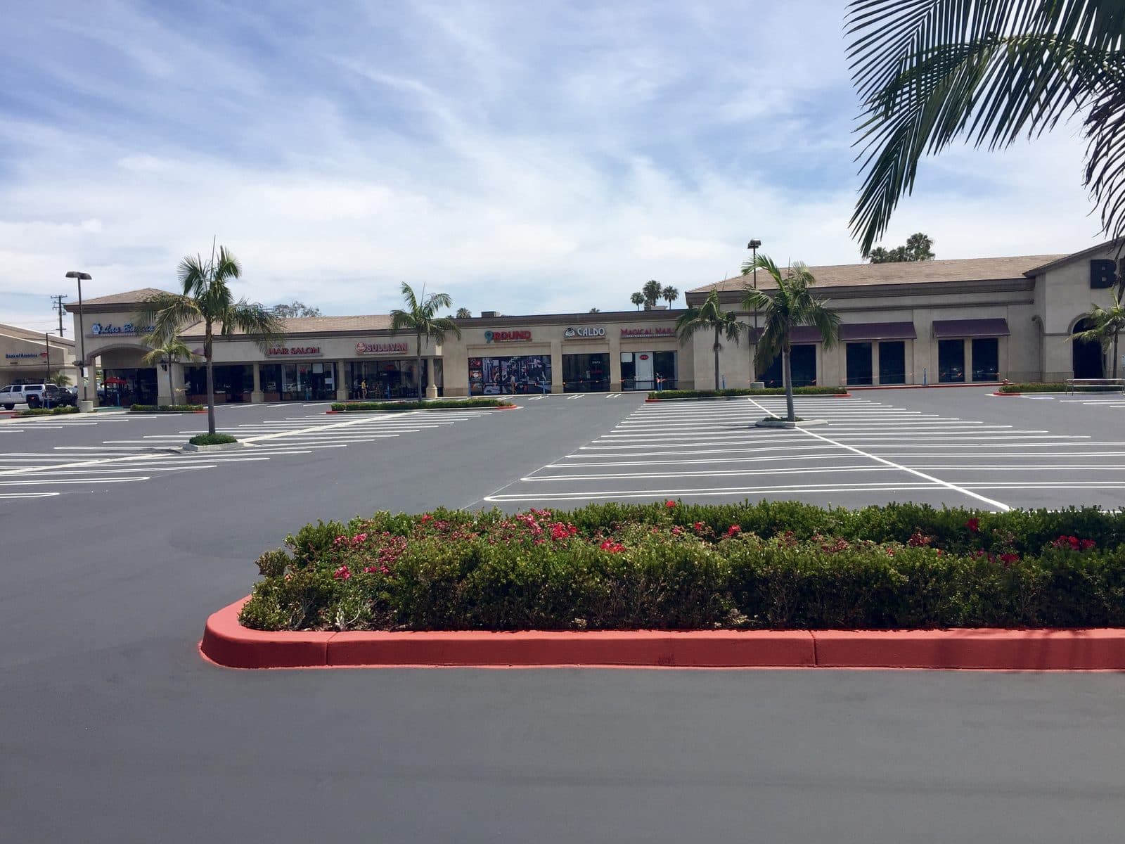 Strip-mall re-stripe with red fire-lane curb